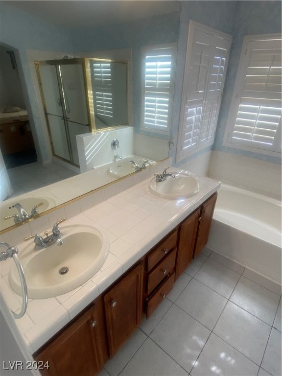 bathroom with tile patterned flooring, shower with separate bathtub, and vanity