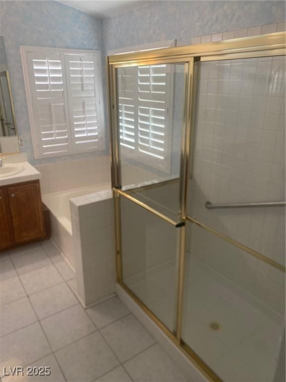 bathroom featuring independent shower and bath, vanity, and tile patterned flooring