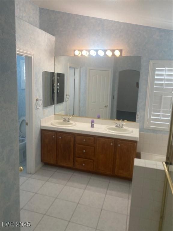 bathroom with tile patterned flooring and vanity