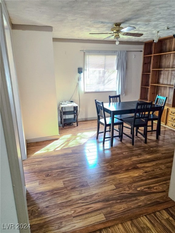 dining room with hardwood / wood-style floors, ceiling fan, and a textured ceiling
