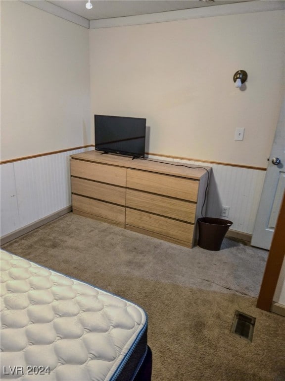 bedroom with light carpet and ornamental molding