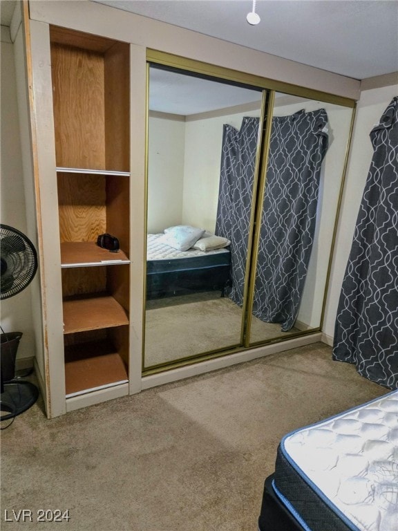 carpeted bedroom with a closet
