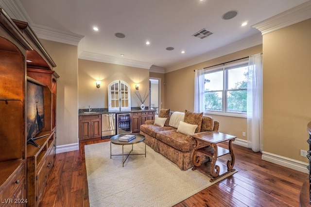 living room featuring hardwood / wood-style flooring, ornamental molding, and beverage cooler