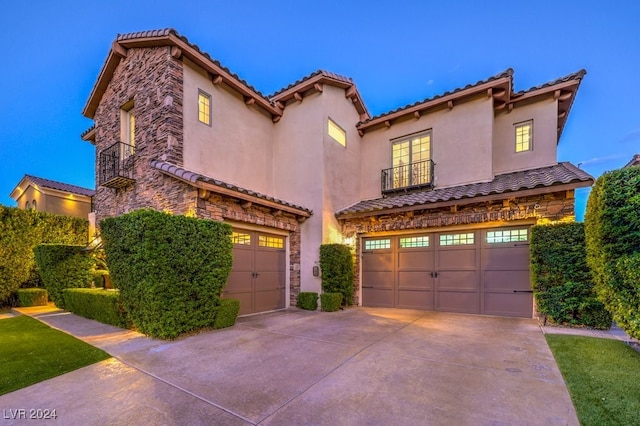 mediterranean / spanish home with a garage