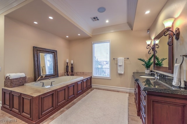 bathroom with crown molding, a washtub, and vanity