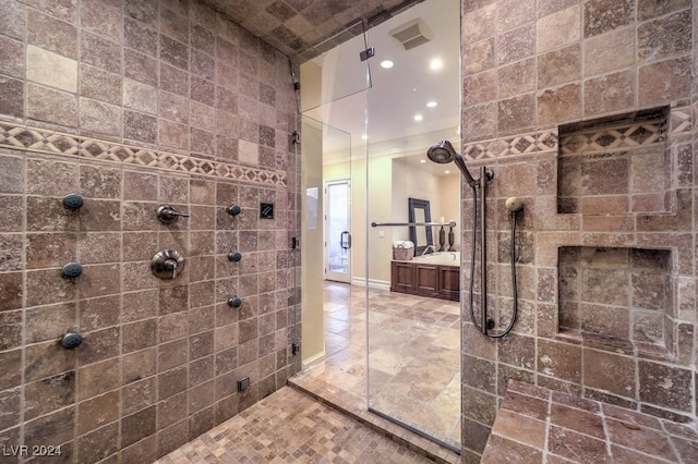 bathroom featuring ornamental molding and a shower with door