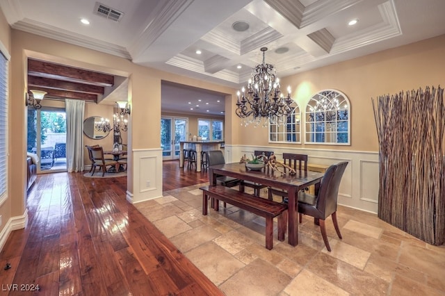 dining area with beamed ceiling, a healthy amount of sunlight, and light wood-type flooring