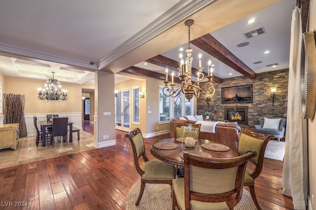 dining room with beam ceiling, a fireplace, wood-type flooring, and ornamental molding