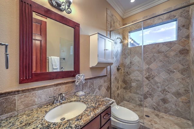 bathroom with an enclosed shower, vanity, crown molding, tile walls, and toilet