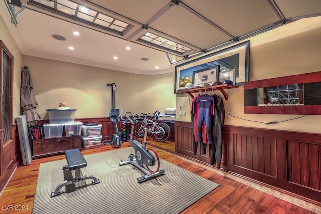 workout room with light hardwood / wood-style floors and ornamental molding