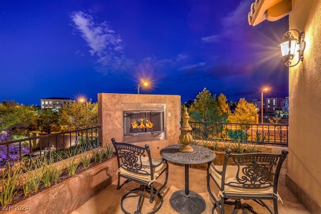 patio at night with a tile fireplace