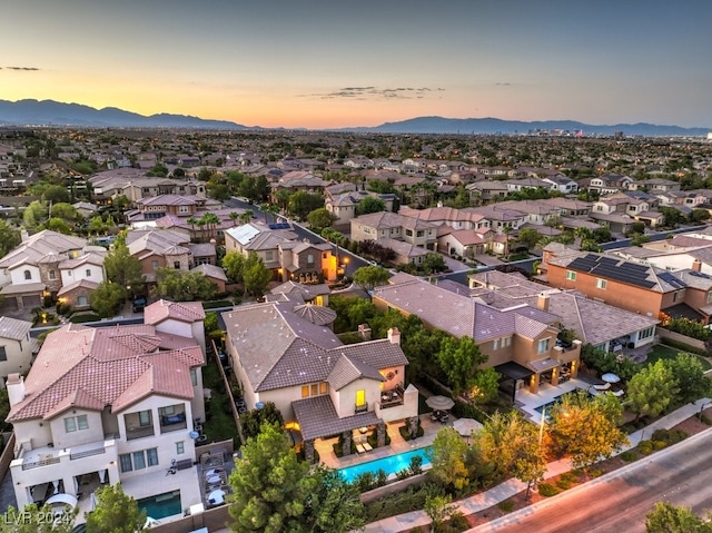 aerial view at dusk featuring a mountain view