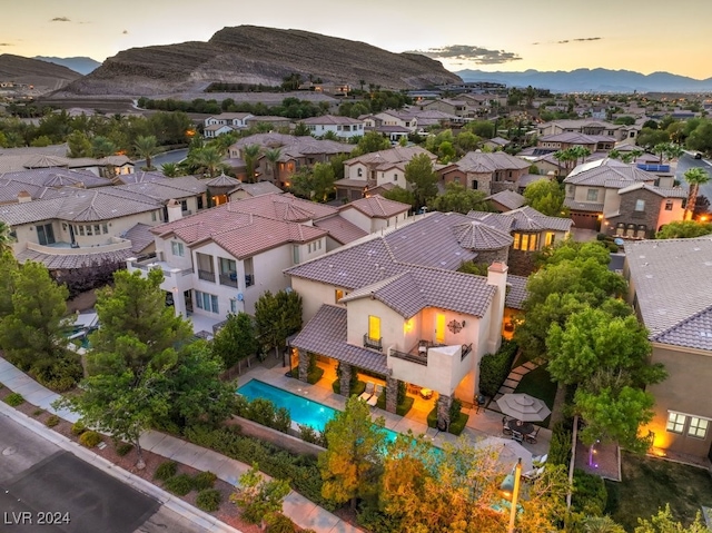 aerial view at dusk featuring a mountain view