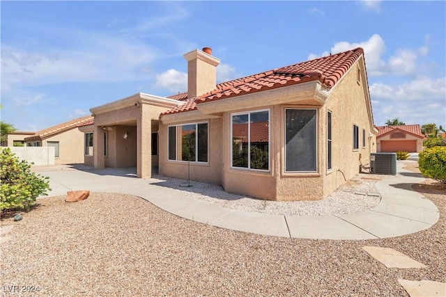 rear view of property featuring central AC and a patio