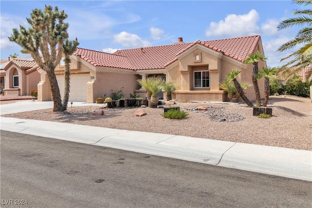 mediterranean / spanish-style house featuring a garage