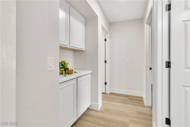 hallway with light hardwood / wood-style flooring