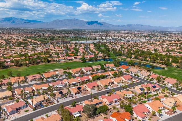 birds eye view of property with a water and mountain view