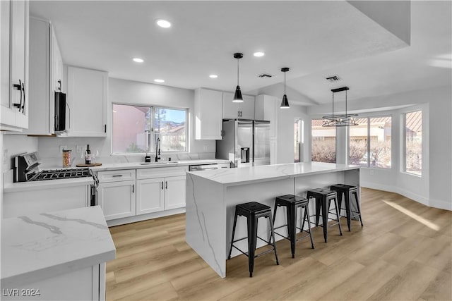 kitchen featuring a center island, white cabinetry, and appliances with stainless steel finishes