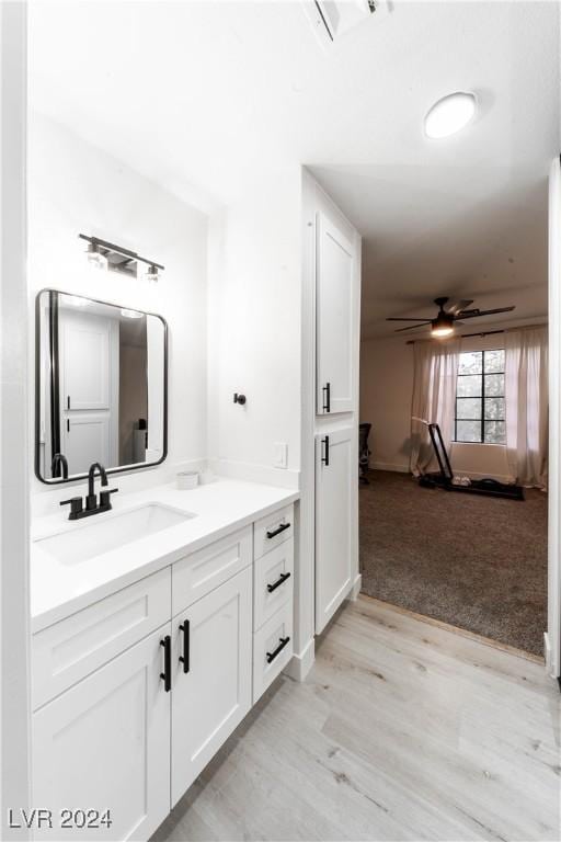 4724 Nara Vista Way Unit 204, Las Vegas, NV 89103 - bathroom featuring vanity, wood finished floors, and a ceiling fan