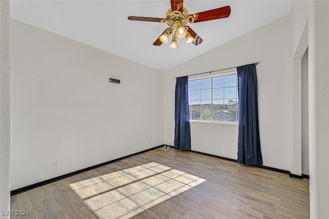 unfurnished room featuring ceiling fan, light wood-type flooring, and vaulted ceiling