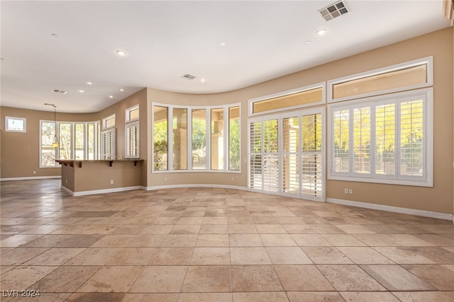 unfurnished living room with a wealth of natural light