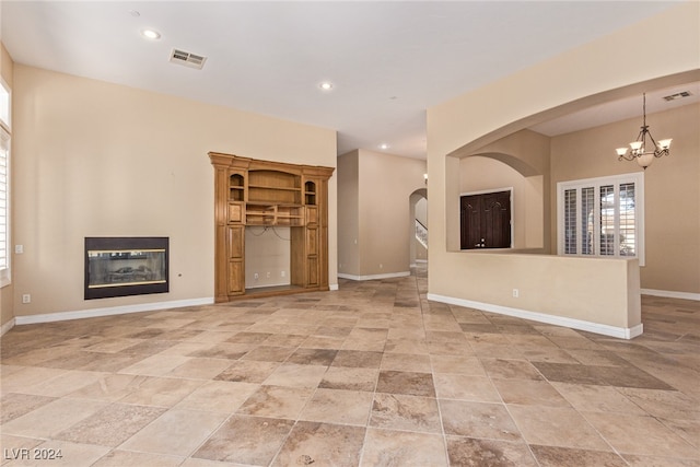 unfurnished living room with an inviting chandelier