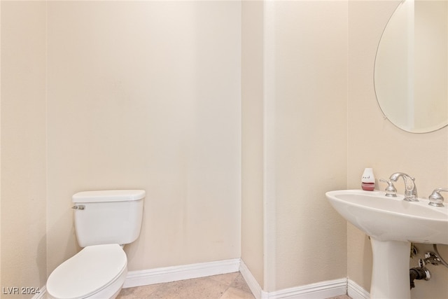 bathroom with tile patterned floors, toilet, and sink