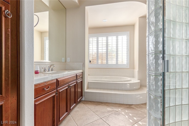 bathroom featuring vanity, independent shower and bath, and tile patterned floors