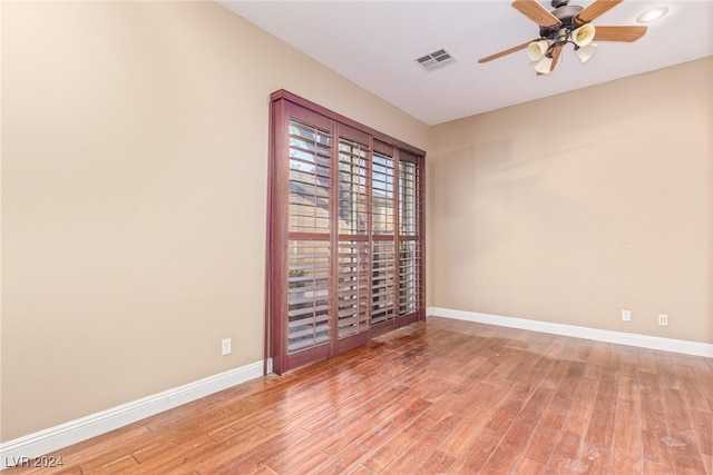 empty room with light wood-type flooring and ceiling fan