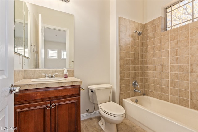 full bathroom with vanity, plenty of natural light, toilet, and tiled shower / bath combo