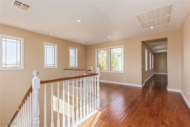 corridor with dark hardwood / wood-style flooring