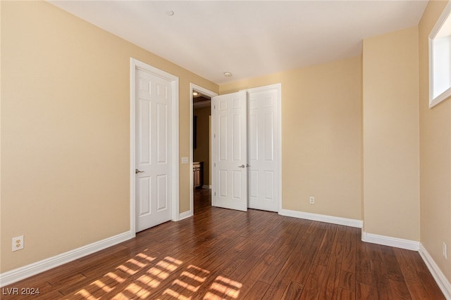 unfurnished bedroom featuring dark wood-type flooring