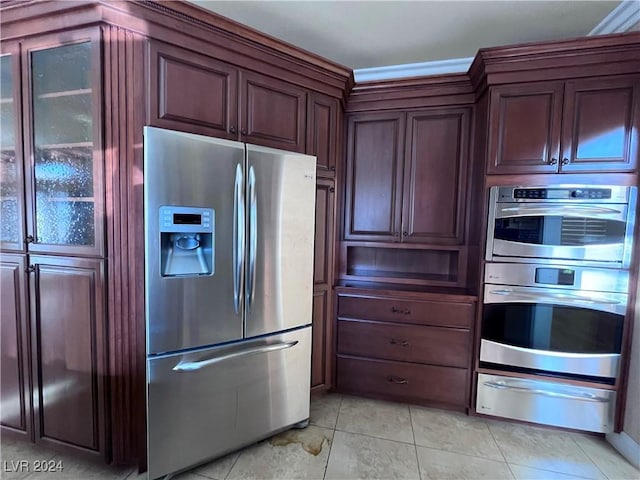 kitchen with light tile patterned flooring and stainless steel appliances