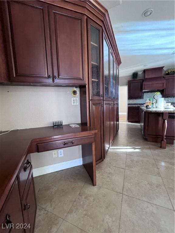 kitchen featuring crown molding, light tile patterned flooring, and custom exhaust hood