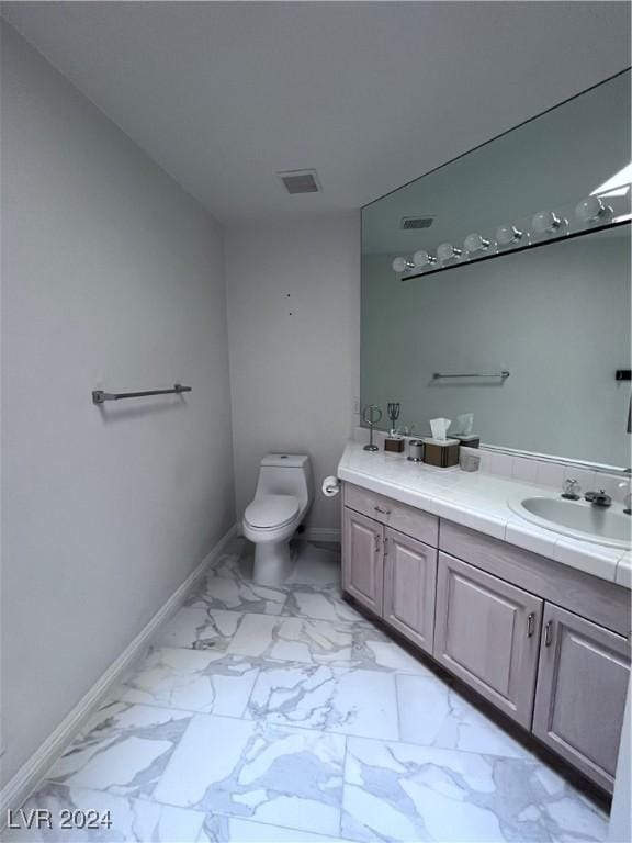 bathroom with vanity and toilet