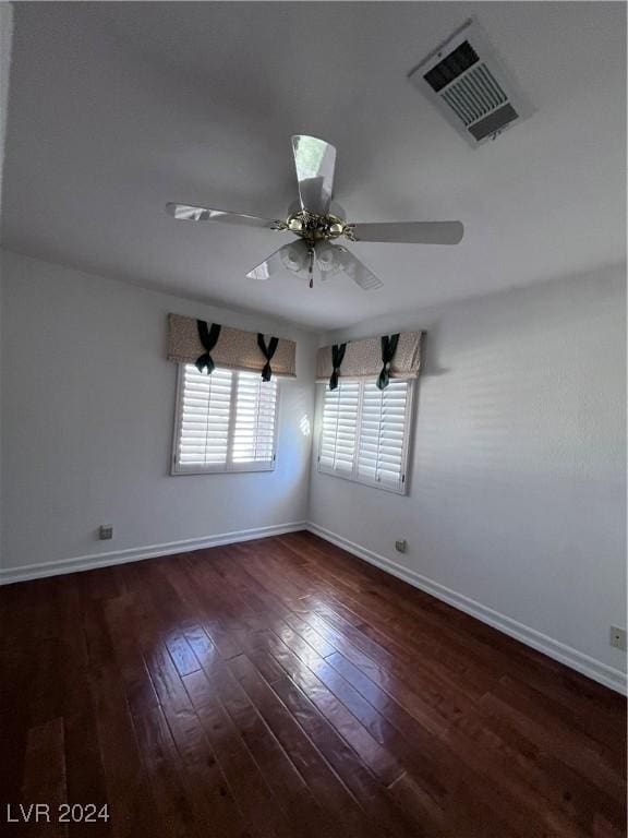 empty room featuring ceiling fan and dark hardwood / wood-style flooring