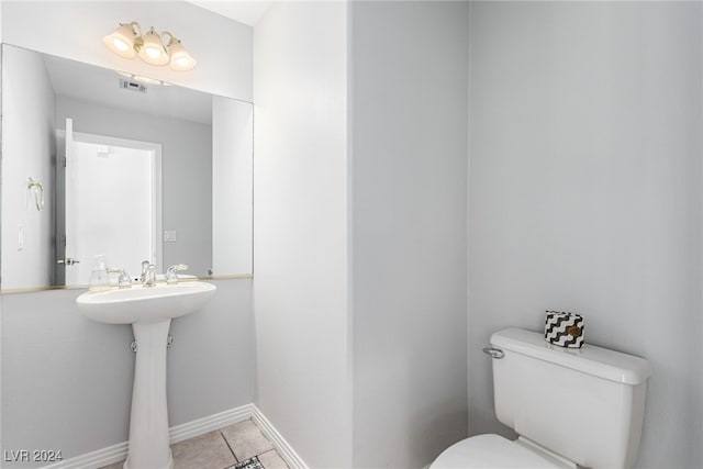 bathroom featuring toilet and tile patterned flooring