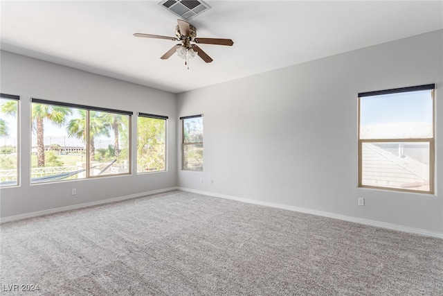 carpeted empty room featuring ceiling fan