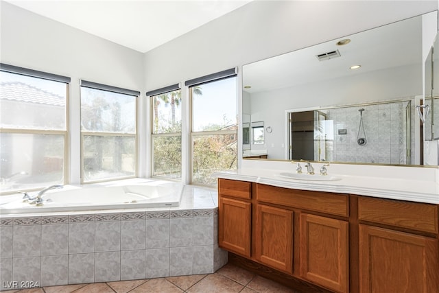 bathroom with vanity, tile patterned floors, and plus walk in shower