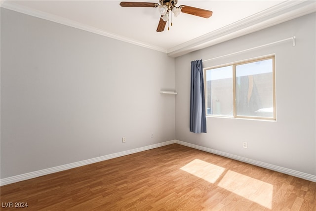 spare room featuring wood-type flooring, ceiling fan, and crown molding