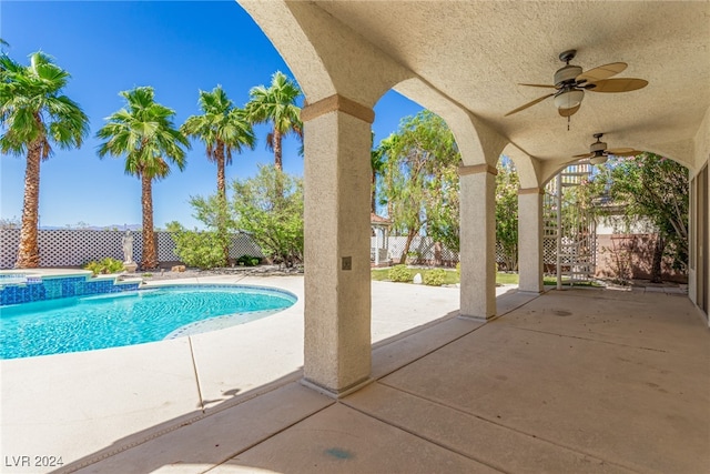 view of swimming pool featuring a patio and ceiling fan