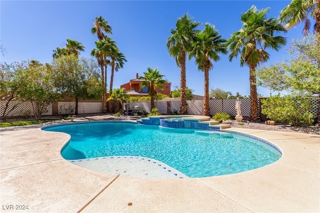 view of pool featuring a patio and an in ground hot tub