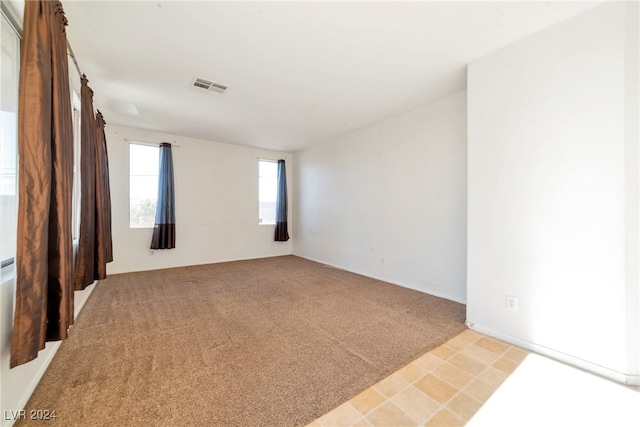 spare room with light colored carpet