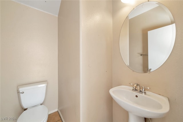 bathroom with tile patterned flooring, toilet, and sink