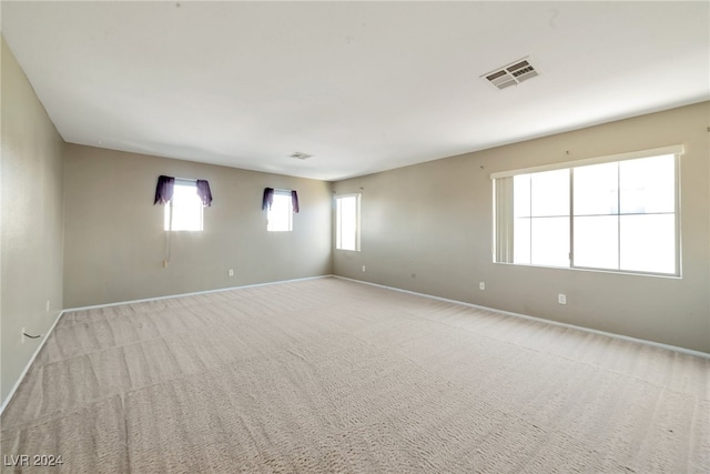 spare room with light carpet