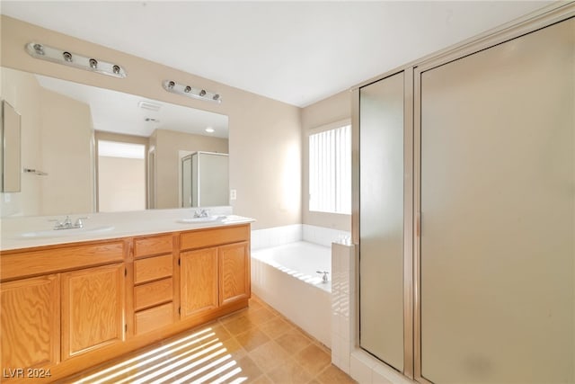 bathroom with vanity and independent shower and bath