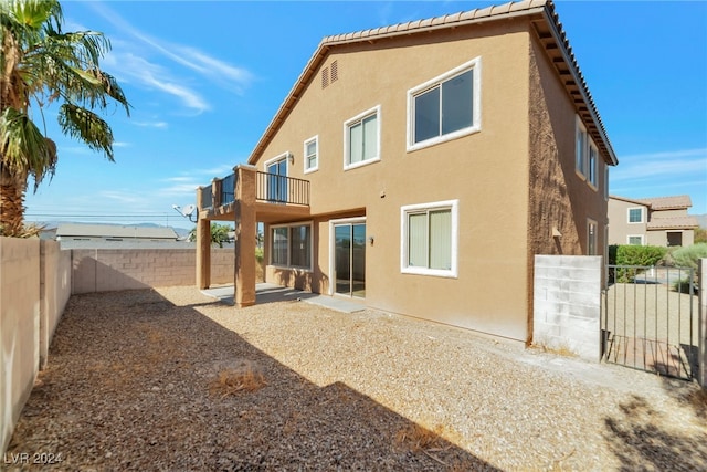 rear view of property with a balcony