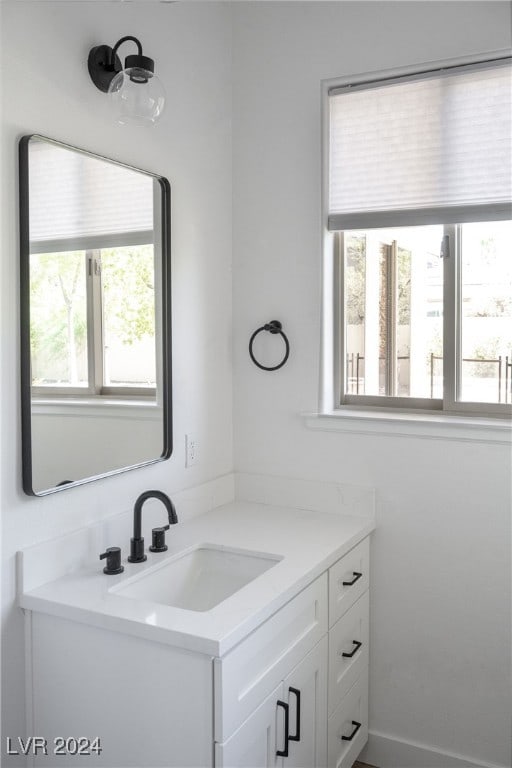 bathroom with plenty of natural light and vanity