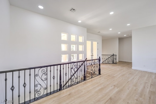 hall featuring french doors and light wood-type flooring