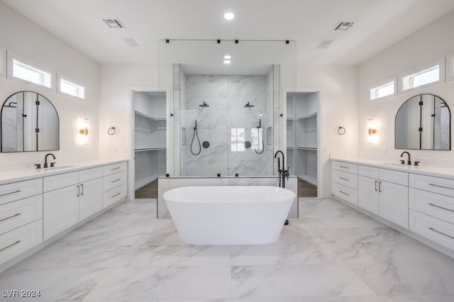 bathroom featuring vanity, plus walk in shower, and a wealth of natural light